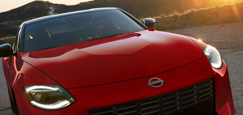 Red Nissan sports car at sunset