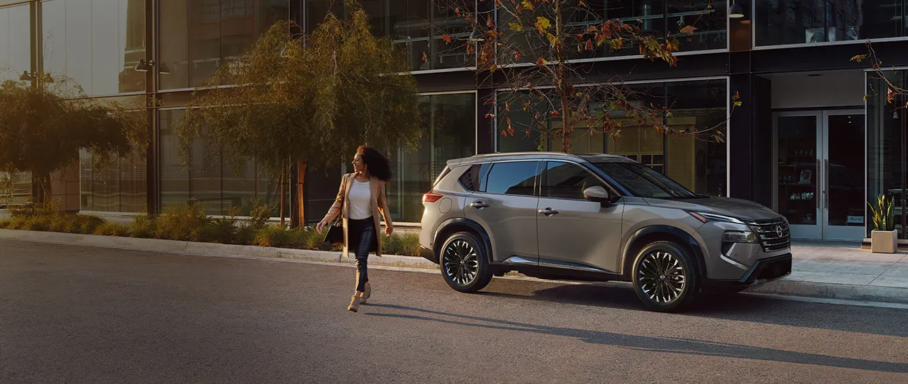 Silver Nissan SUV parked outside a modern building