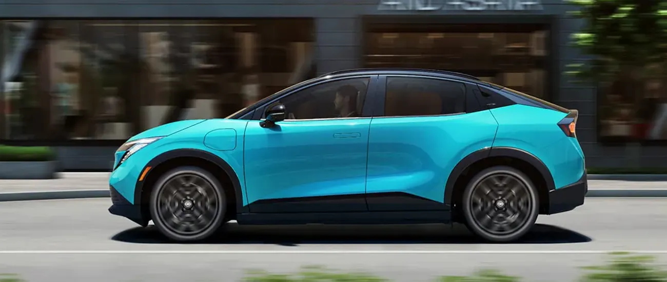 Blue Nissan electric crossover driving through the city