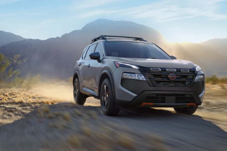 Gray Nissan SUV traveling through a mountainous landscape
