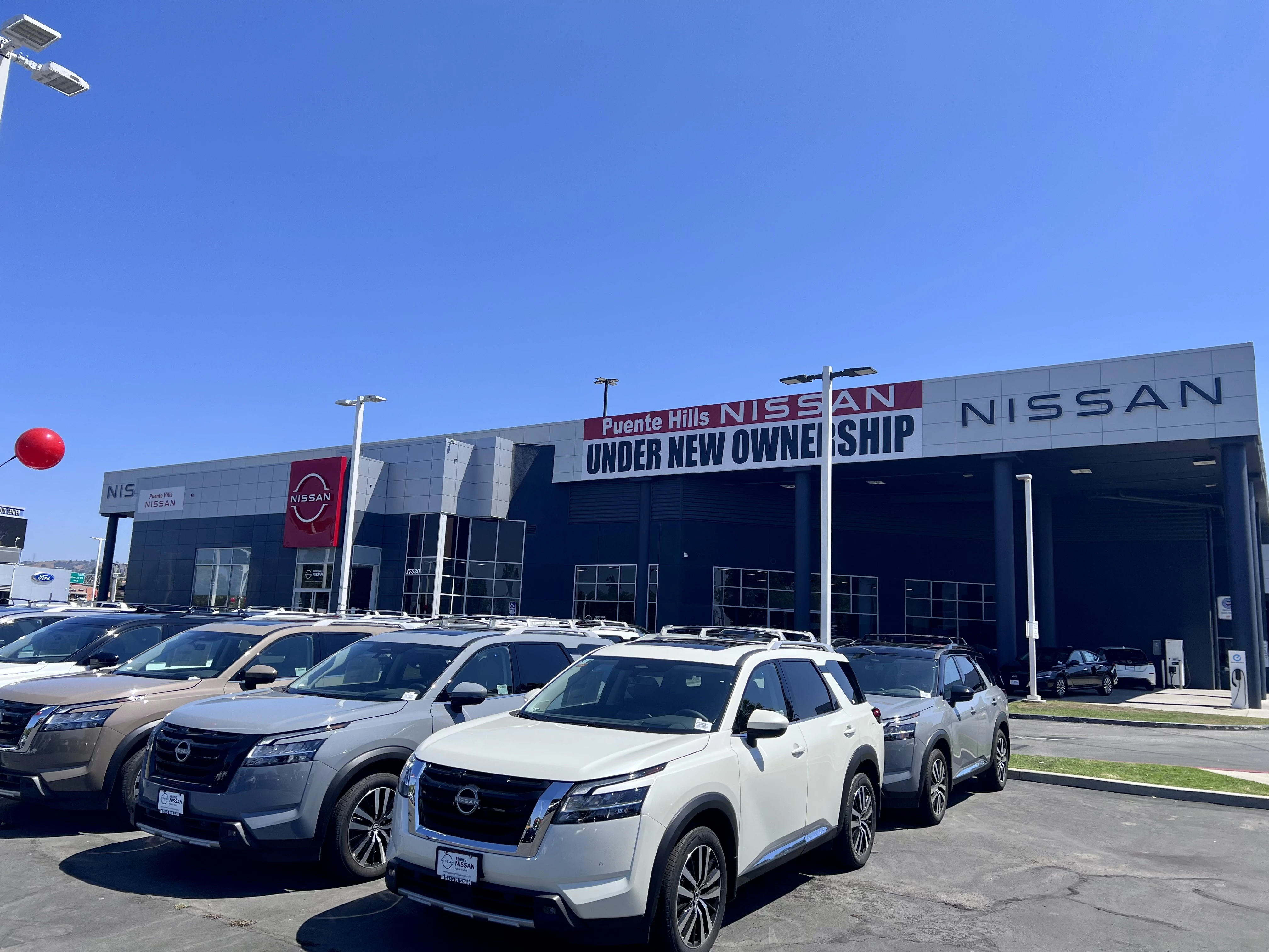 Puente Hills Nissan dealership lot with vehicles parked