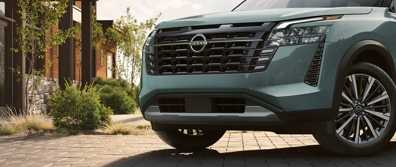 Front view of Nissan SUV parked by a home
