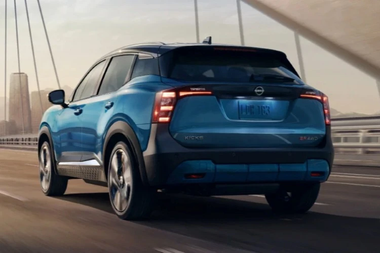 Rear three-quarter view of a blue Nissan Kicks showing the full-width taillights