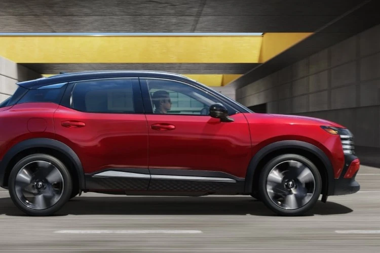 Red Nissan Kicks in a parking structure, shown from the front three-quarter angle