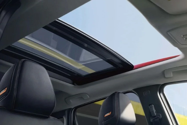 View upward through the open panoramic moonroof of a Nissan Kicks