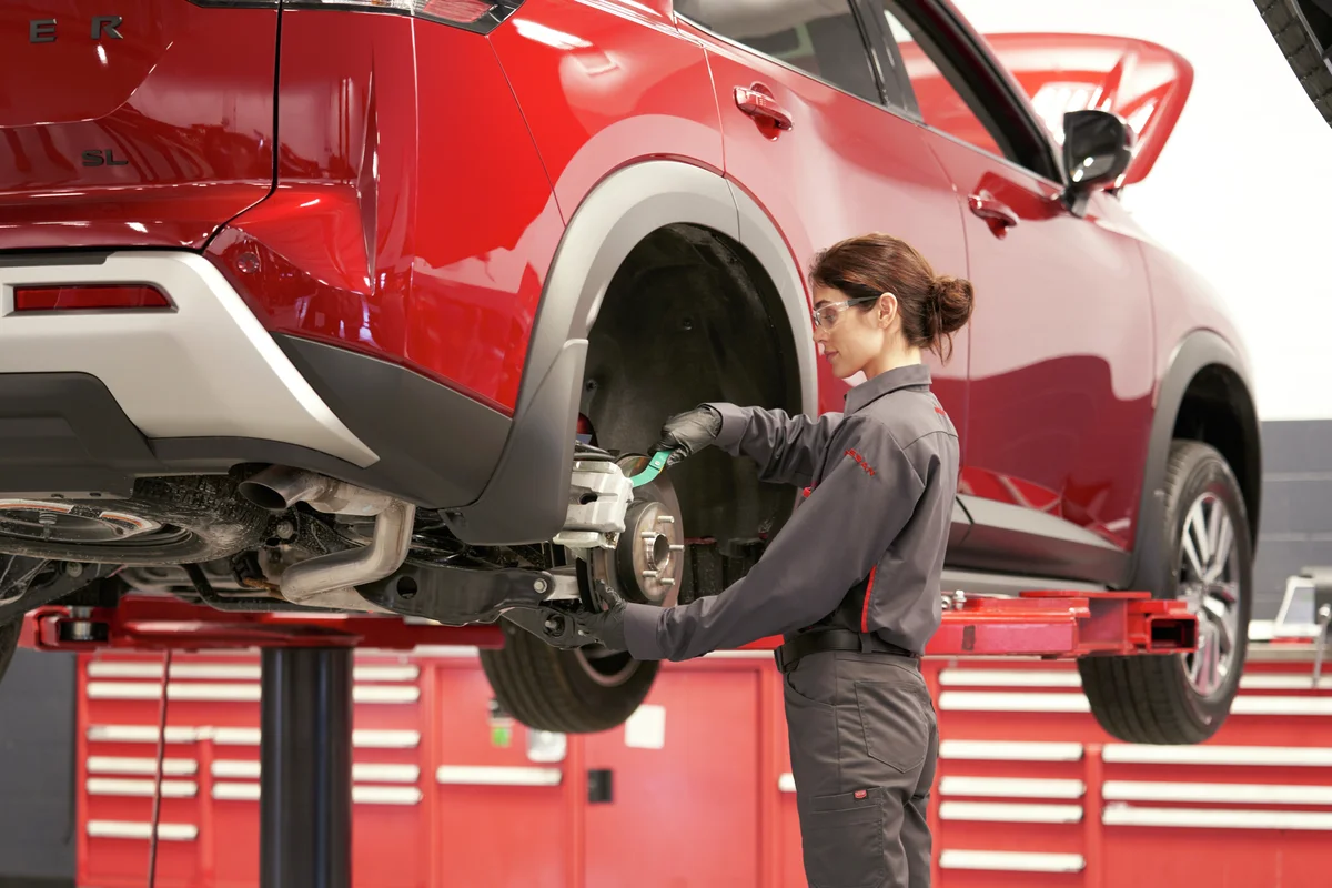 Technician servicing a Nissan vehicle