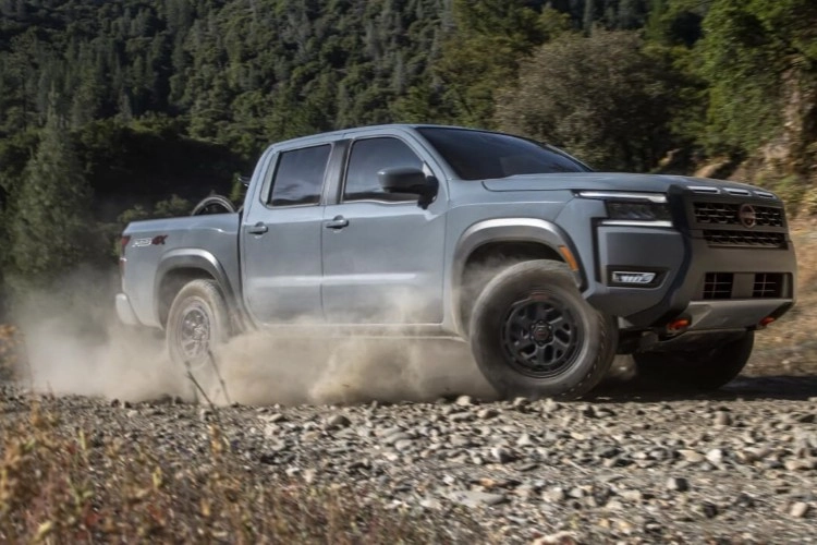 Nissan Frontier PRO-4X kicking up dust on a gravel trail