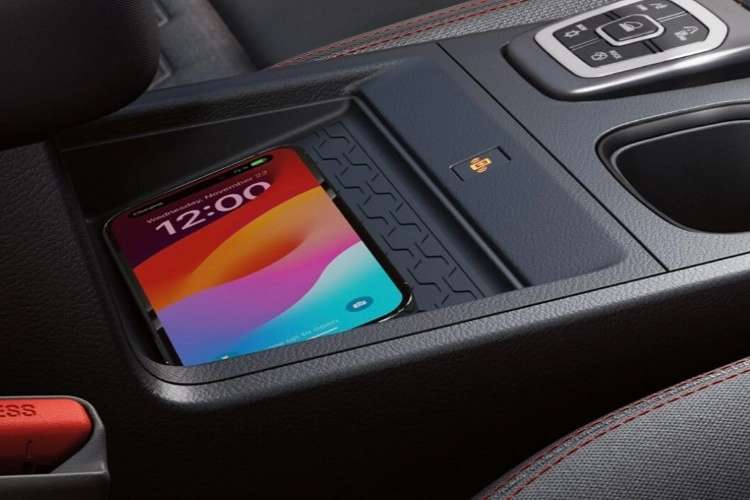 Smartphone charging wirelessly on the pad in the Nissan Frontier centre console
