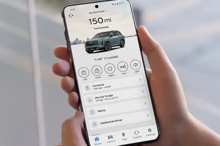 Hand holding phone showing MyNISSAN app with Altima vehicle status