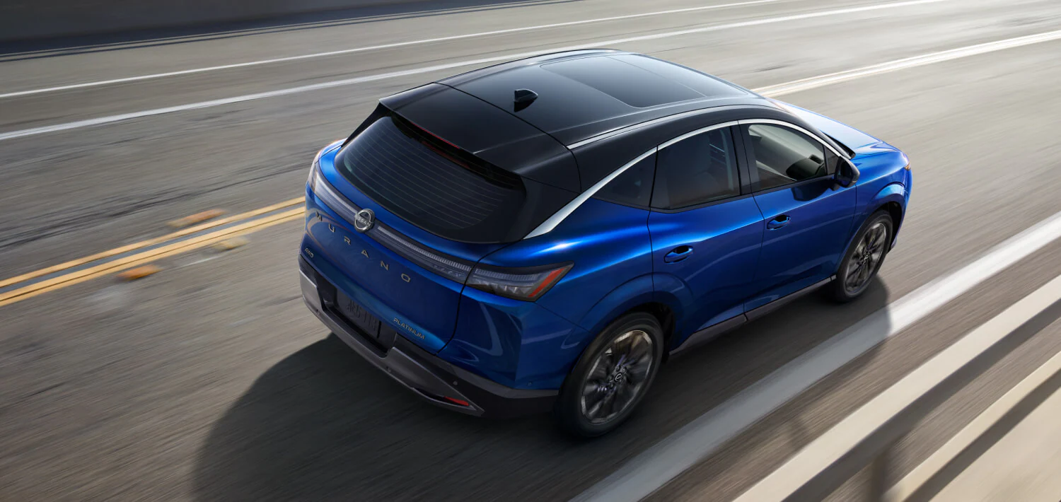 Blue Nissan Ariya driving on a highway