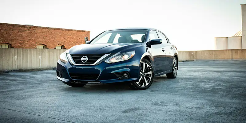 Blue Nissan sedan parked outdoors