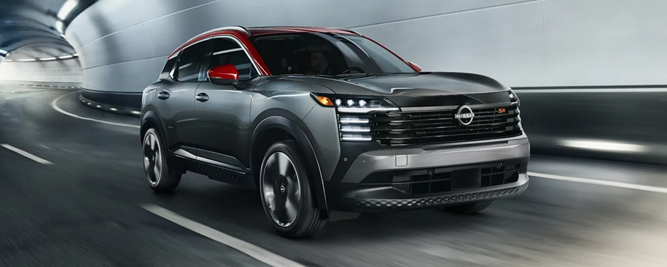 Gray Nissan SUV with a red roof driving through a tunnel