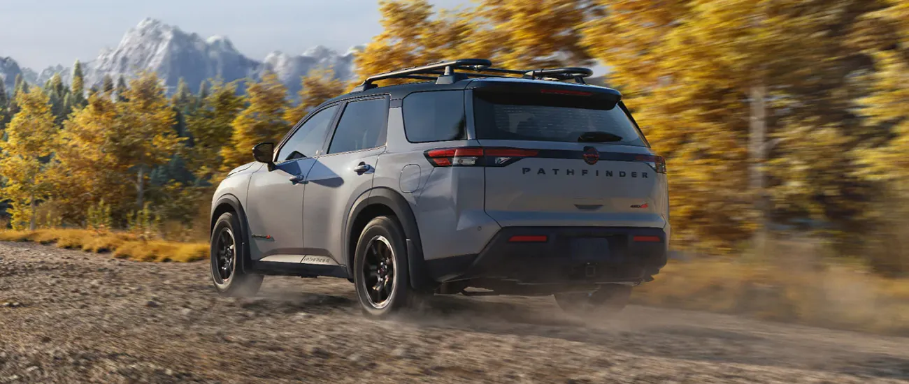 Rear view of Nissan Pathfinder driving on a mountain trail