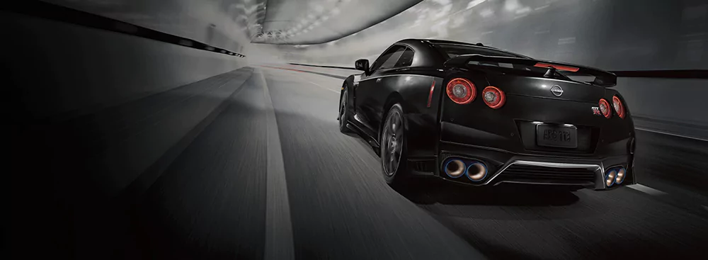 Black GT-R driving through tunnel