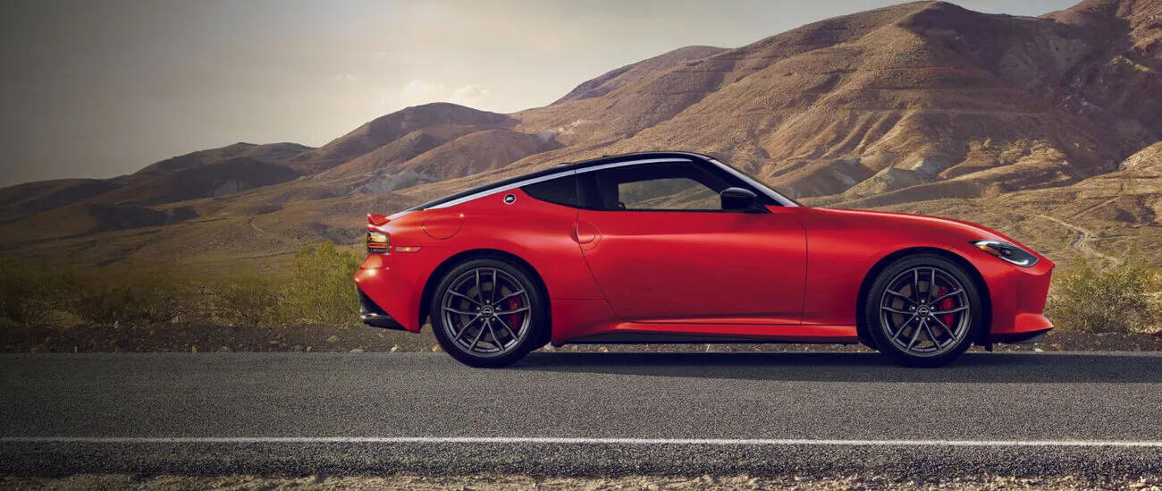 Red Nissan Z parked on a mountain road