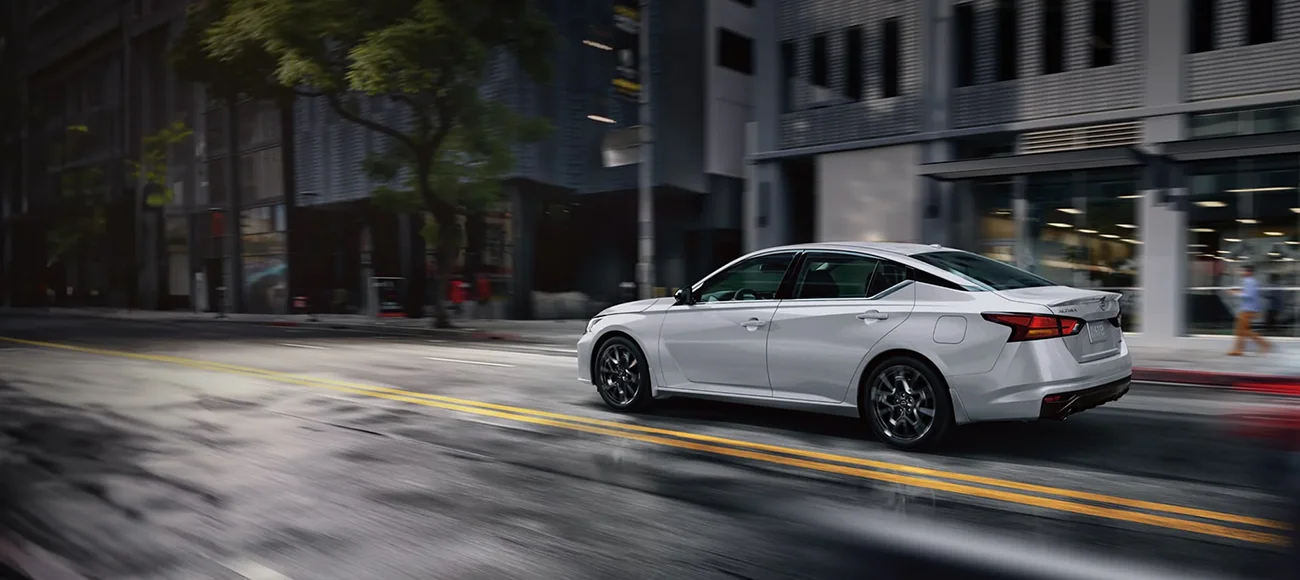 Silver Altima driving through city