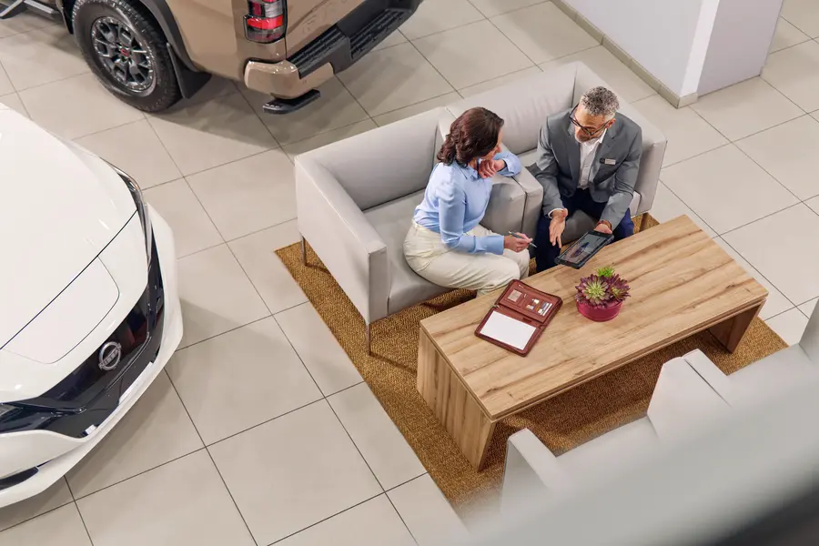 Customers meeting at a Nissan dealership