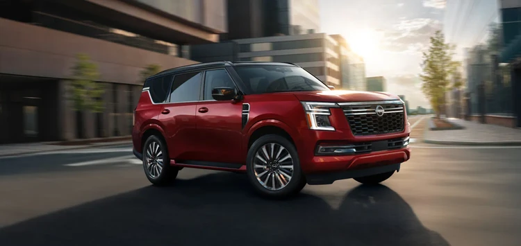 2025 Nissan Armada driving through a city center showing a contrasting roof