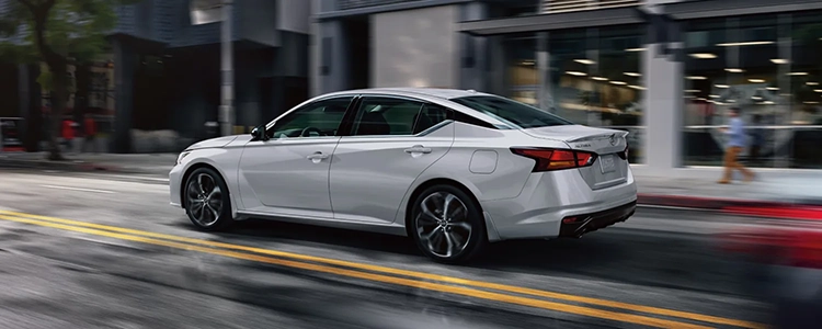 White 2025 Nissan Altima Driving Down Street