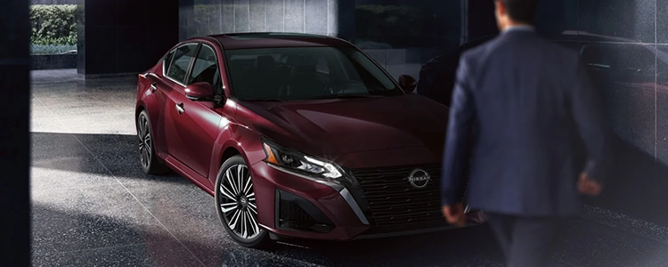 Man Walking Toward Parked Red 2025 Nissan Altima