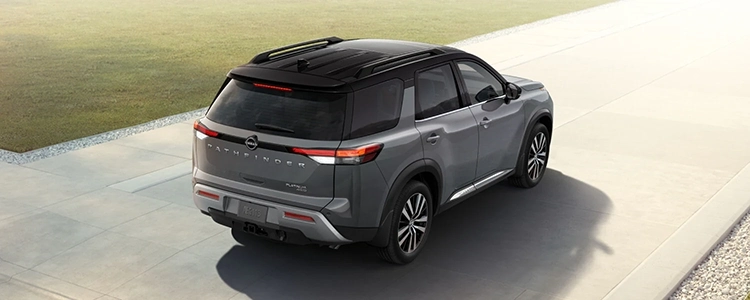 Back Three-Quarters of a Grey 2025 Nissan Pathfinder® Parked in a Driveway