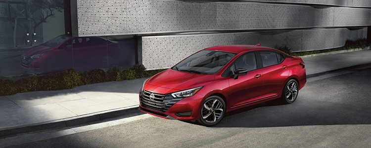 Red 2025 Nissan Versa® Parked by a Sidewalk