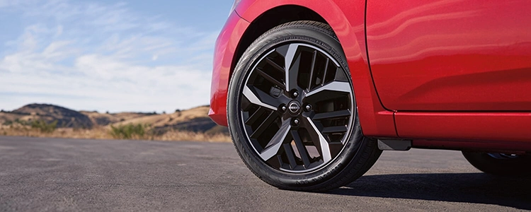 Front Tire of a Red 2025 Nissan Versa®