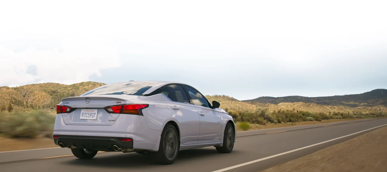 White Altima driving