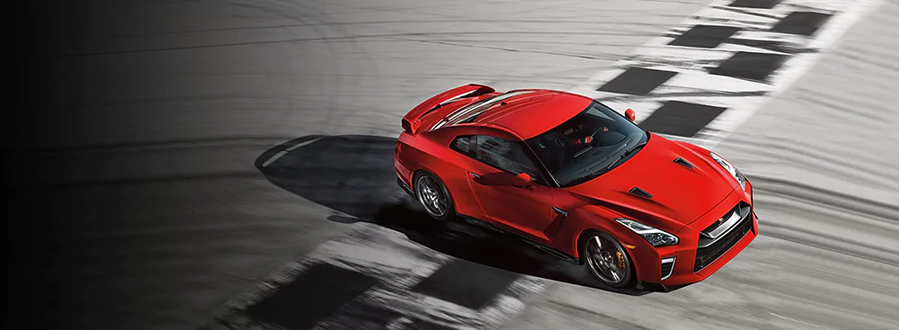 Red GT-R driving on racetrack